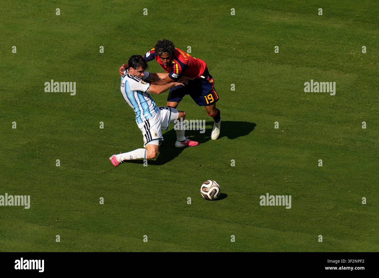 Spain's Lamine Yamal (19) and Argentina's Nicolas Tagliafico (3) fight