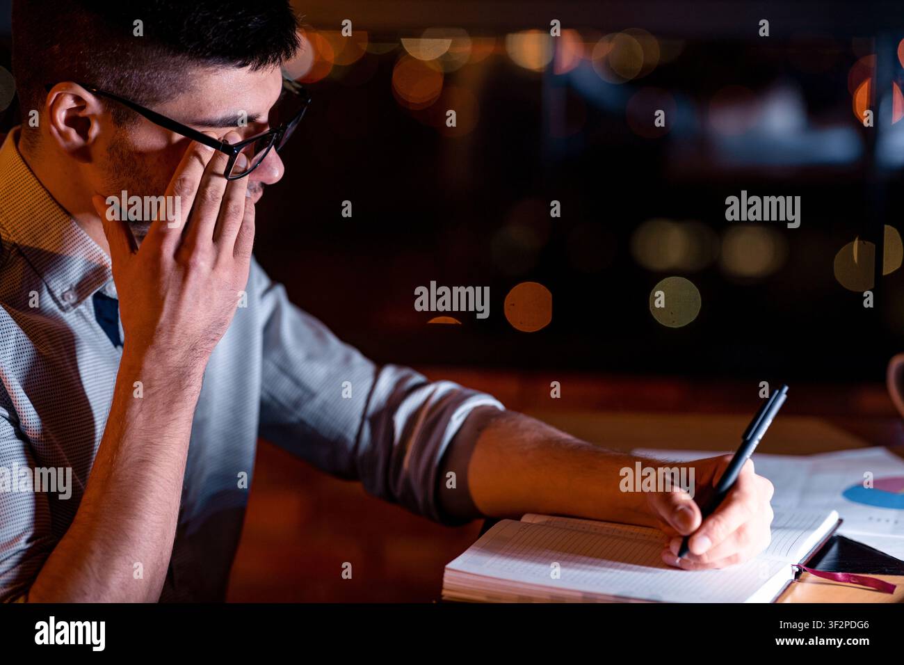 Man Touching Aching Eye Working In Dark Office Room Stock Photo