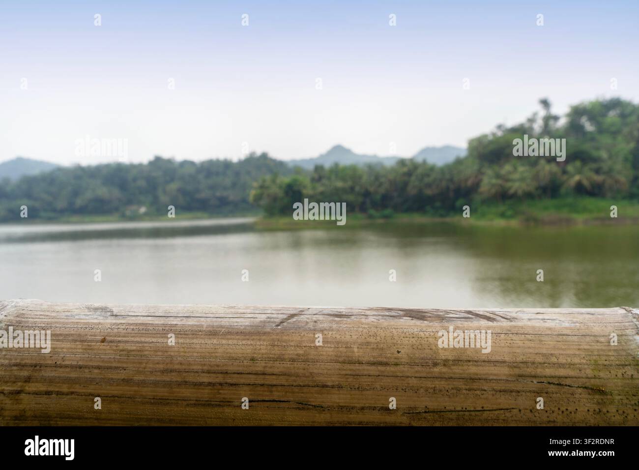 empty bamboo table with blurry lake background Stock Photo