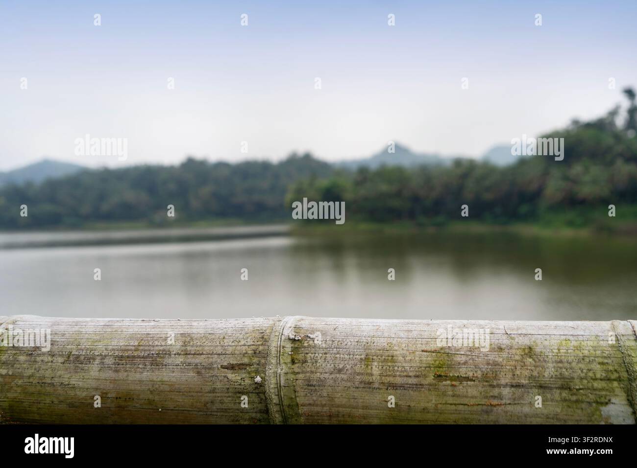 empty bamboo table with blurry lake background Stock Photo