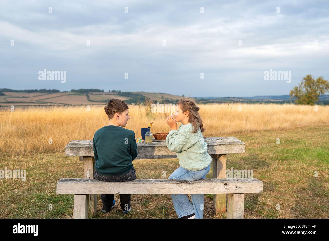 Brother and sister sitting together after outdoor craft activity Stock Photo