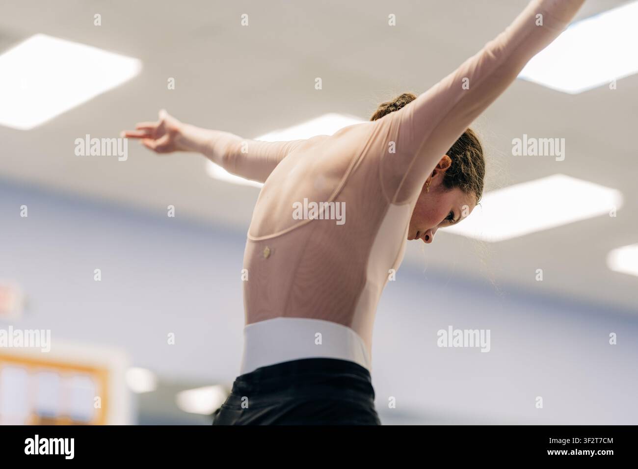 Female dancer practicing elegant movements during ballet rehearsal Stock Photo