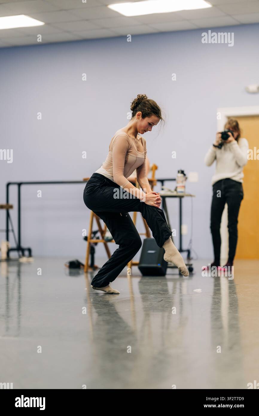 Dancer practicing movement in studio during rehearsal Stock Photo
