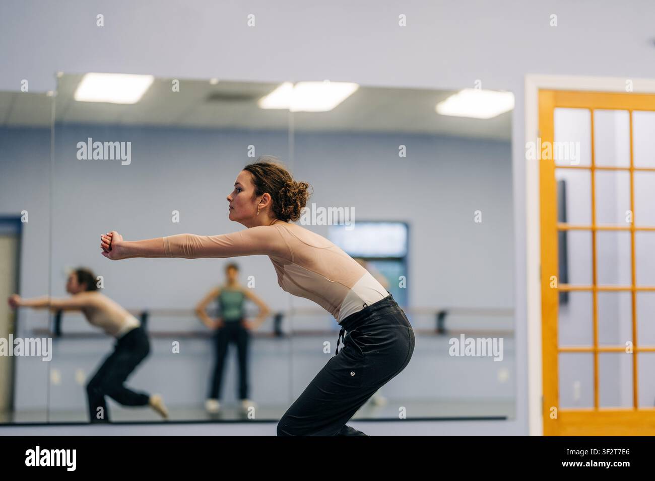 Female dancer practicing movement in studio rehearsal Stock Photo