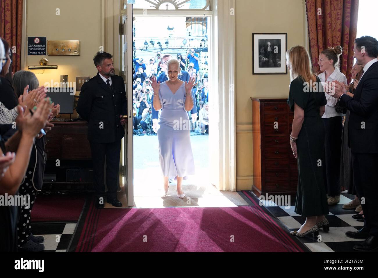 Staff clap as Marie-France van Heel and her husband, new Prime Minister