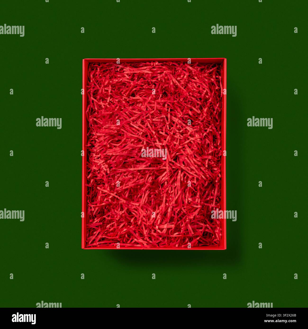 Open Red Gift Box on green background. Stock Photo