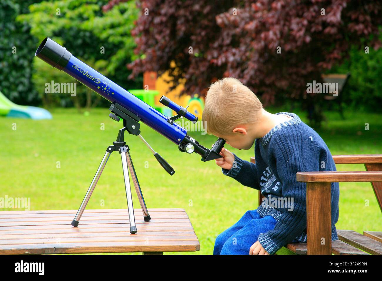 Boy looking through a telescope. Stock Photo