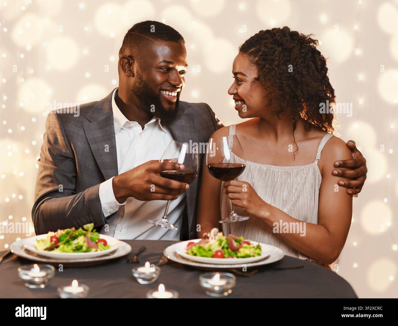 Young black couple having festive dinner at restaurant Stock Photo
