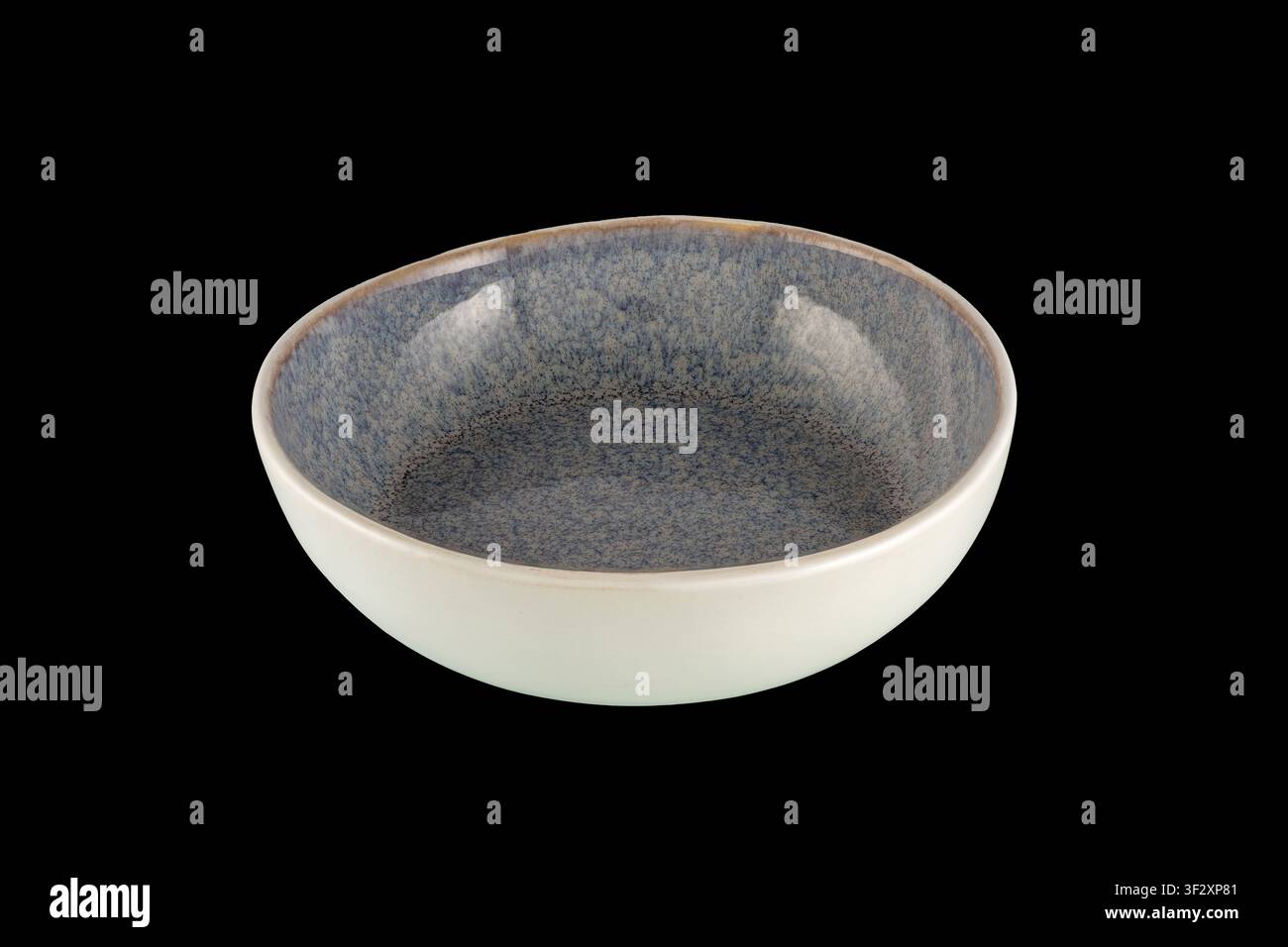Blue speckled ceramic bowl photographed on a black background, empty and centered for product display; minimalist stoneware tableware ideal for food s Stock Photo