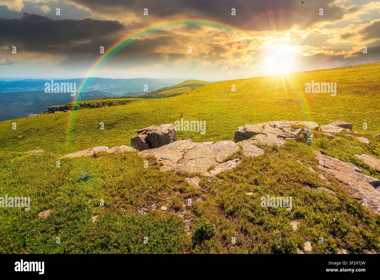 sunset over carpathian mountain landscape in summer. nice background for outdoor adventure in evening light. transcarpathia green hill with rocks Stock Photo