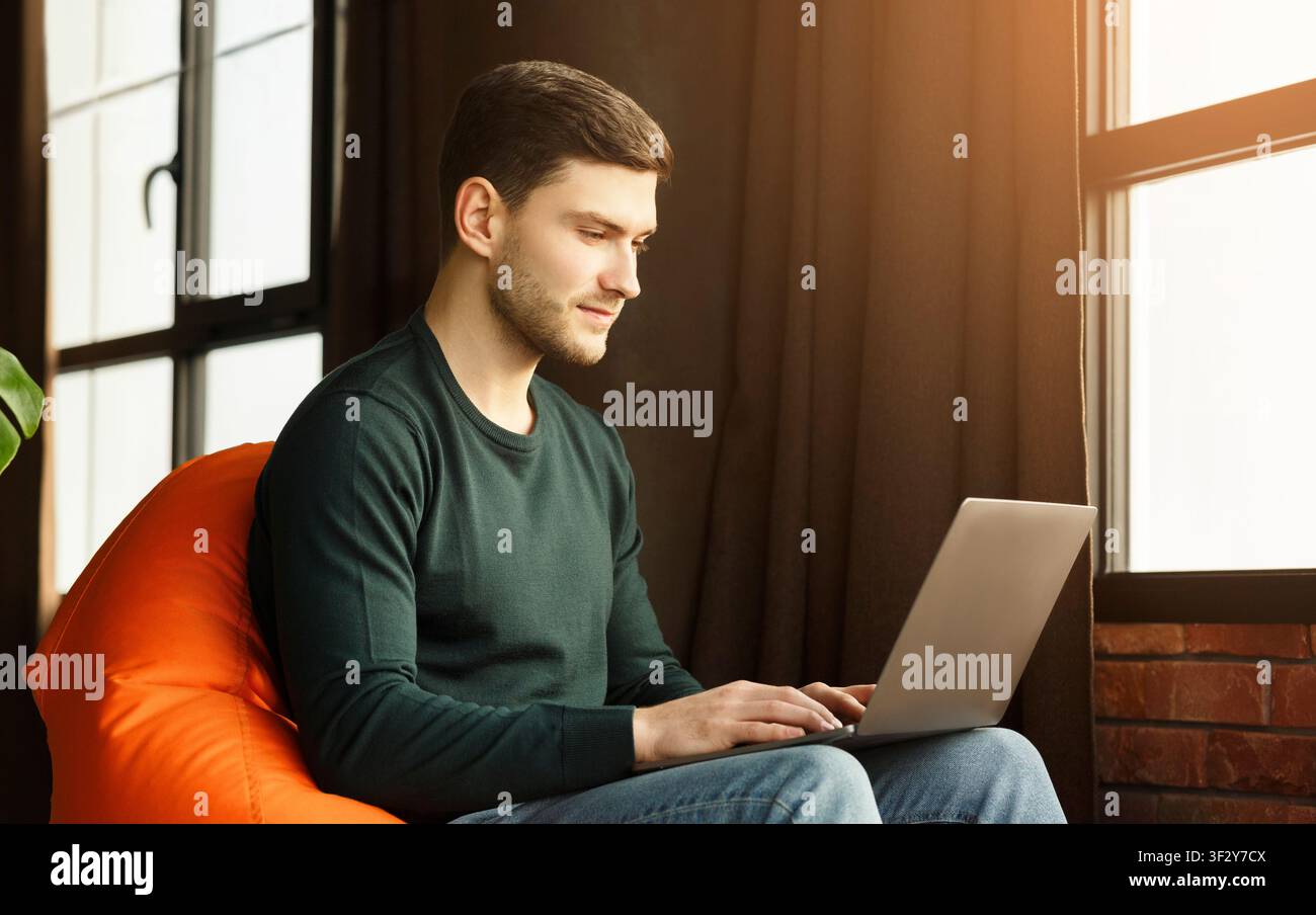 Freelancer Man Using Laptop Sitting In Workspace Indoor Stock Photo