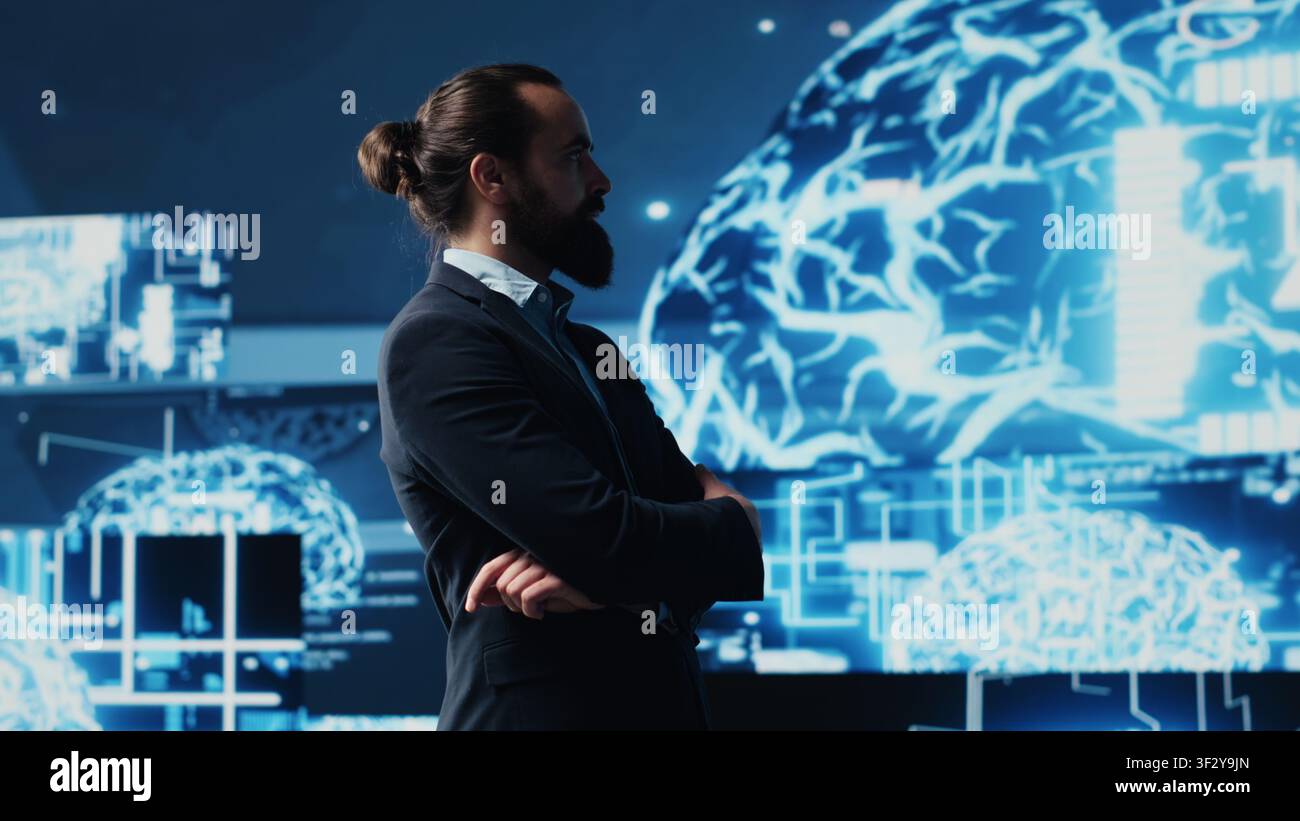 Male entrepreneur works on implementing AI brain system for deep learning, employing neural networks and cybernetics for growth. Using smart technology and algorithmic thinking. Camera A. Stock Photo