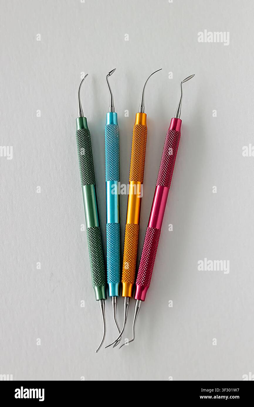 Color coded dental composite modeling instruments on white background Stock Photo