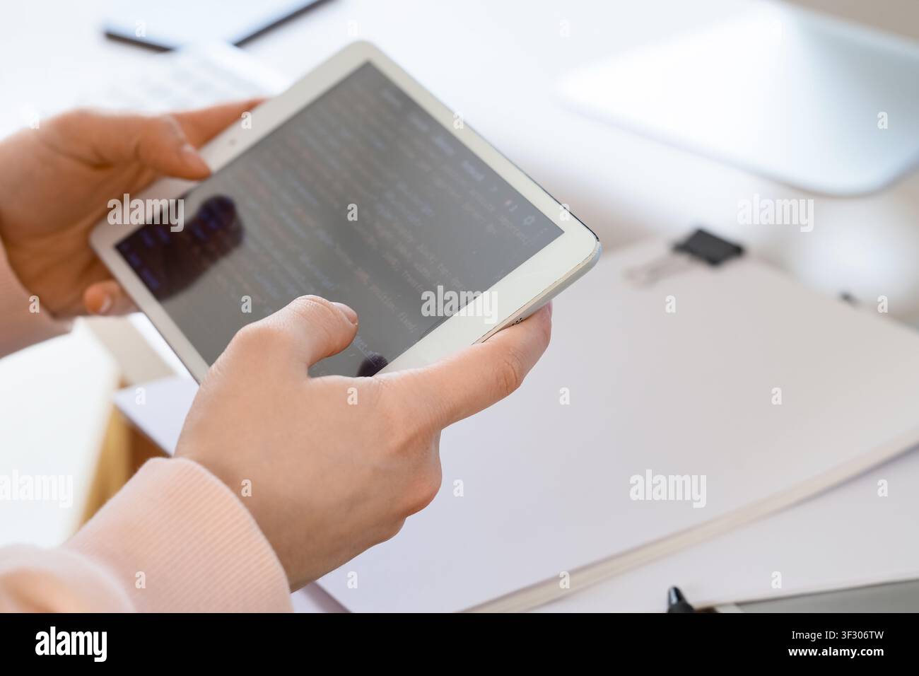 Female programmers hands testing code on tablet computer in office, closeup Stock Photo