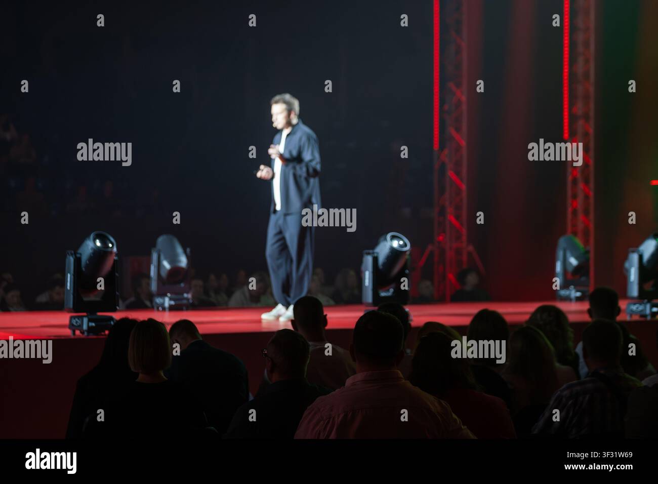 Dynamic speaker captivating an audience, perfect for promoting corporate events and conferences. Stock Photo