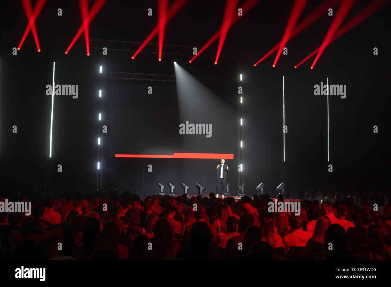 Dynamic speaker captivating an audience, making it ideal for conference highlights. Stock Photo