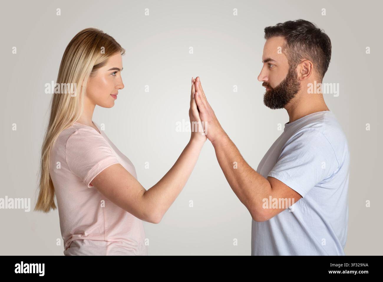 Focused Woman And Man Engaging In Connection, Touching Hands, Emotional Communication Concept Stock Photo