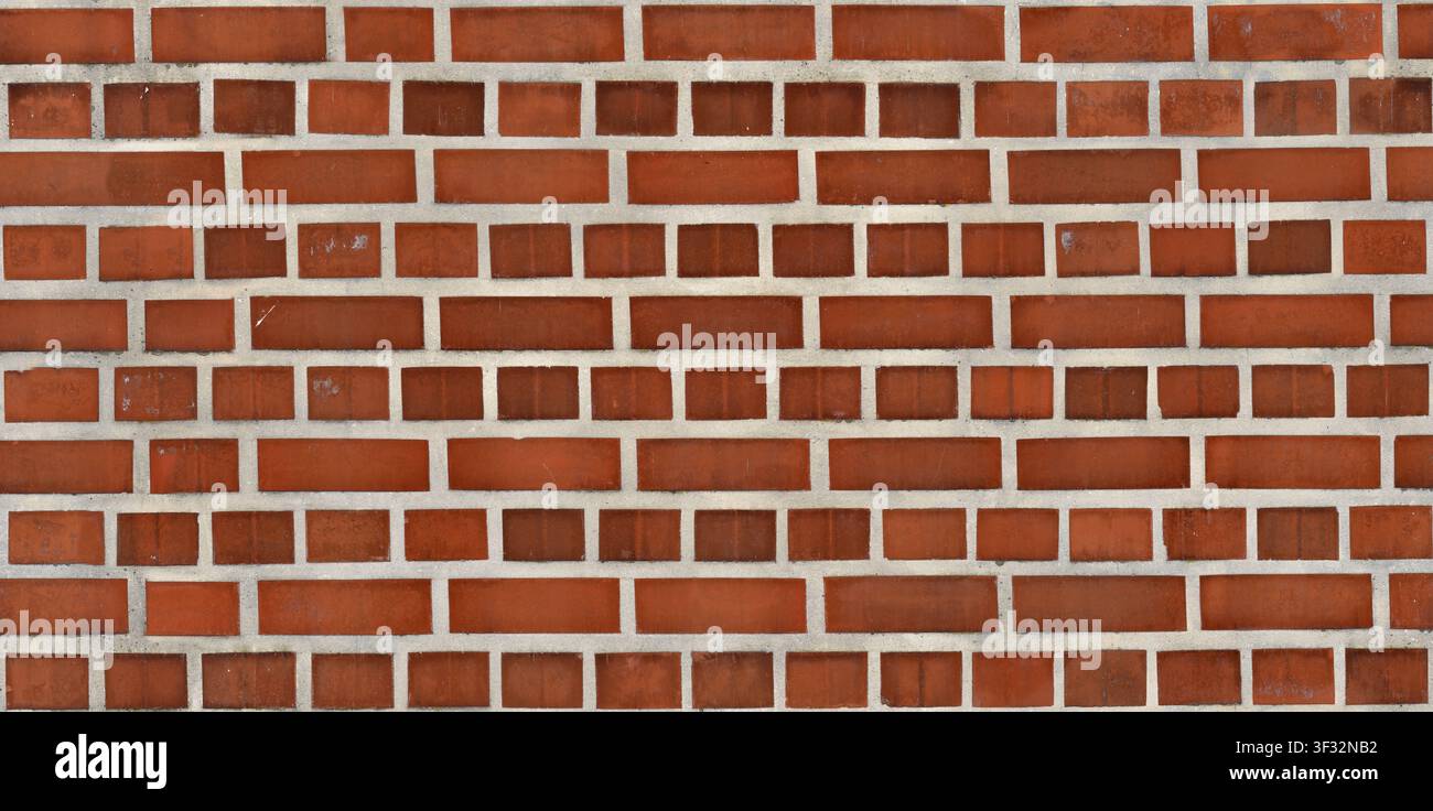A seamless texture of an decorative red brick wall featuring alternating horizontal and vertical brick placement. Stock Photo