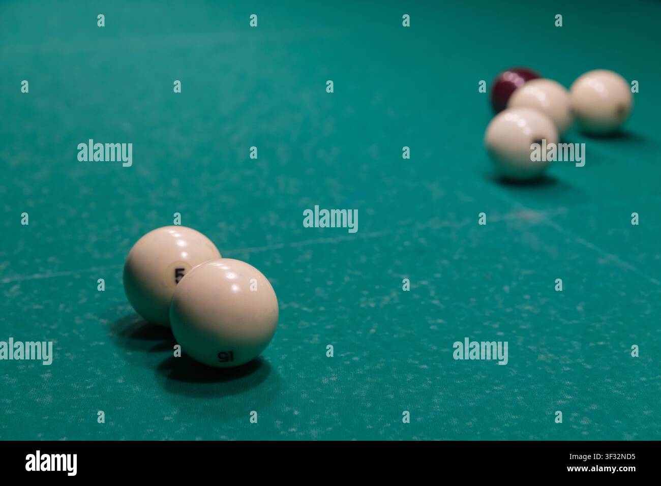 Billiard Balls Arranged on a Green Pool Table with Copy Space Stock Photo