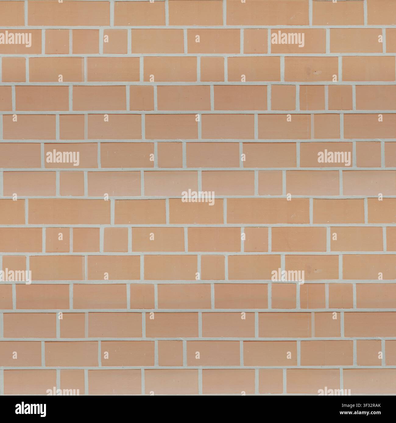 A clean modern light orange brick wall texture featuring an alternating rectangular and square block pattern with white mortar. Stock Photo