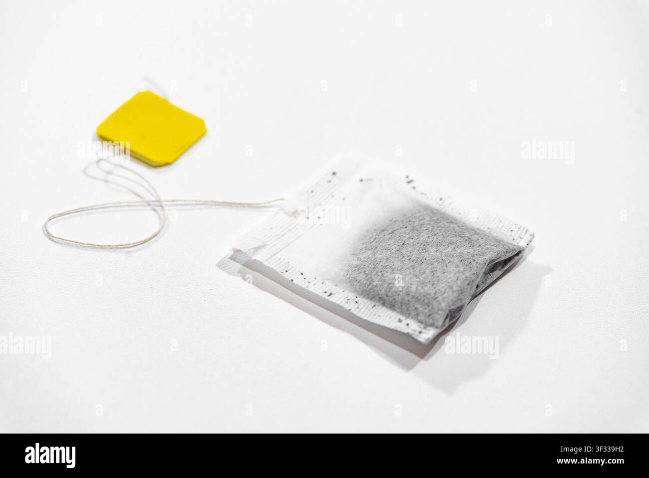 Single tea bag ready for brewing isolated on a clean white background Stock Photo