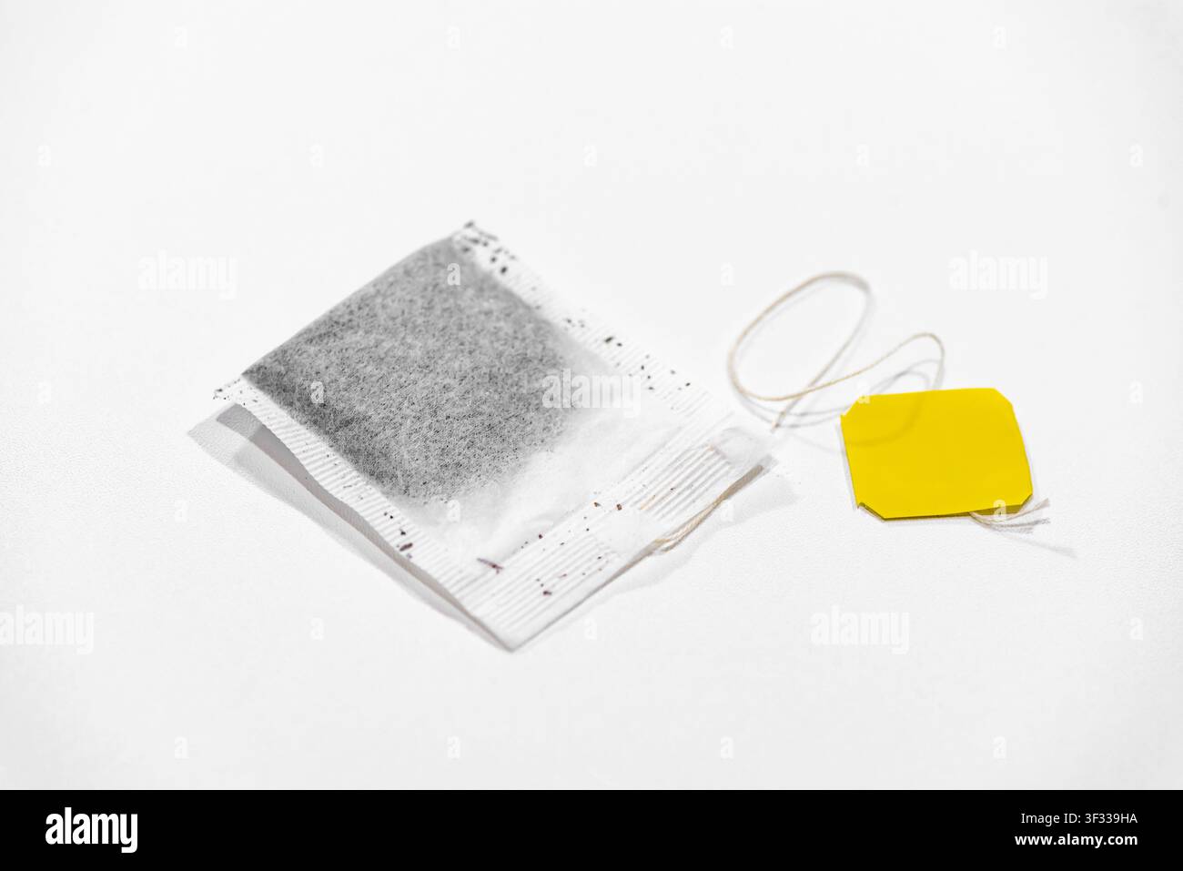 Single tea bag ready for brewing isolated on a clean white background Stock Photo