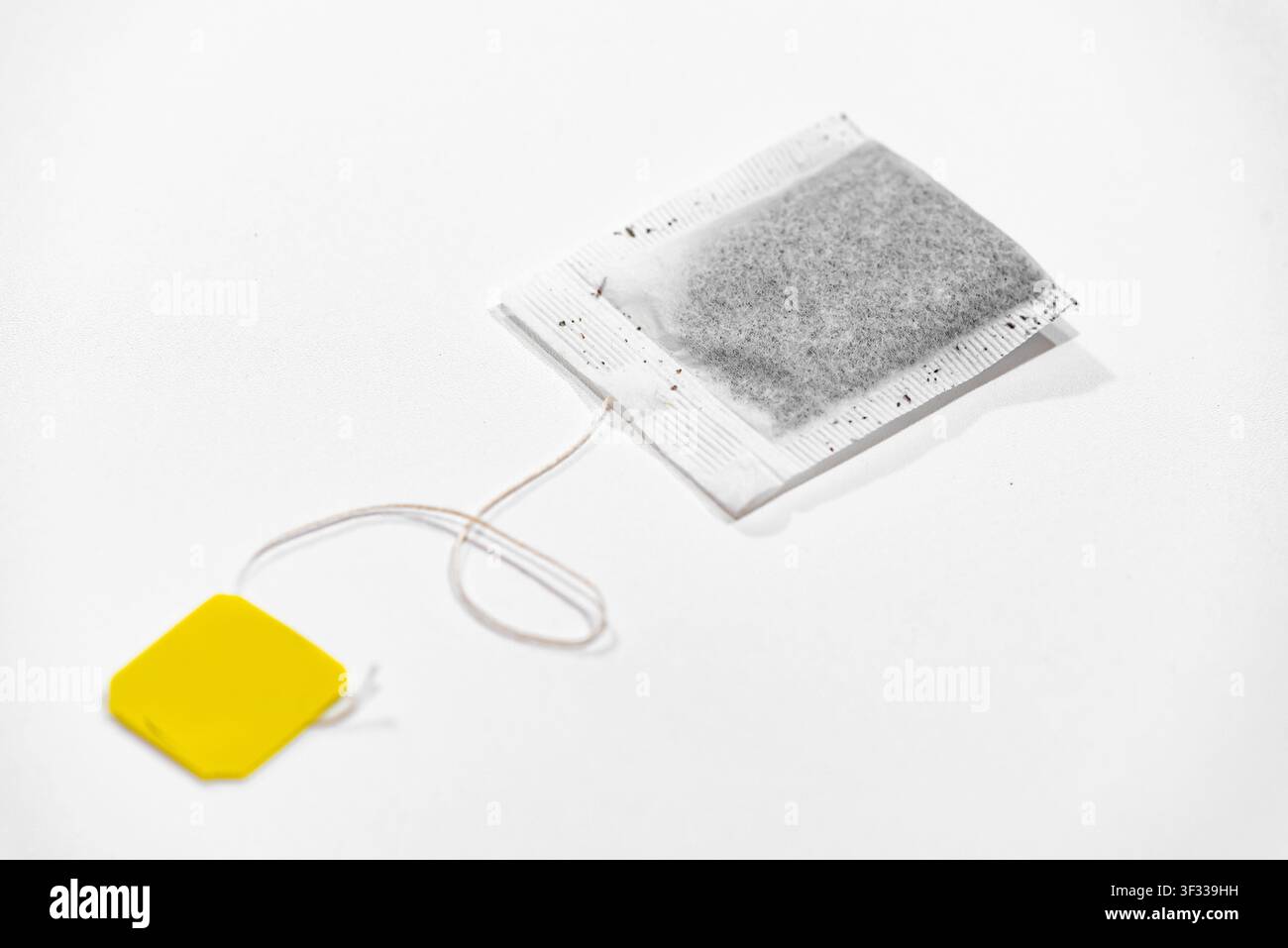 Single tea bag ready for brewing isolated on a clean white background Stock Photo