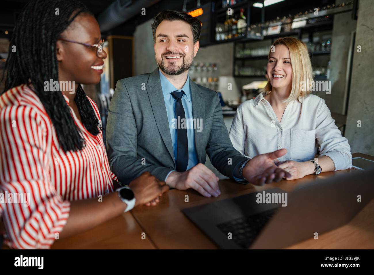 Business professionals collaborating at casual meeting discussing ideas Stock Photo
