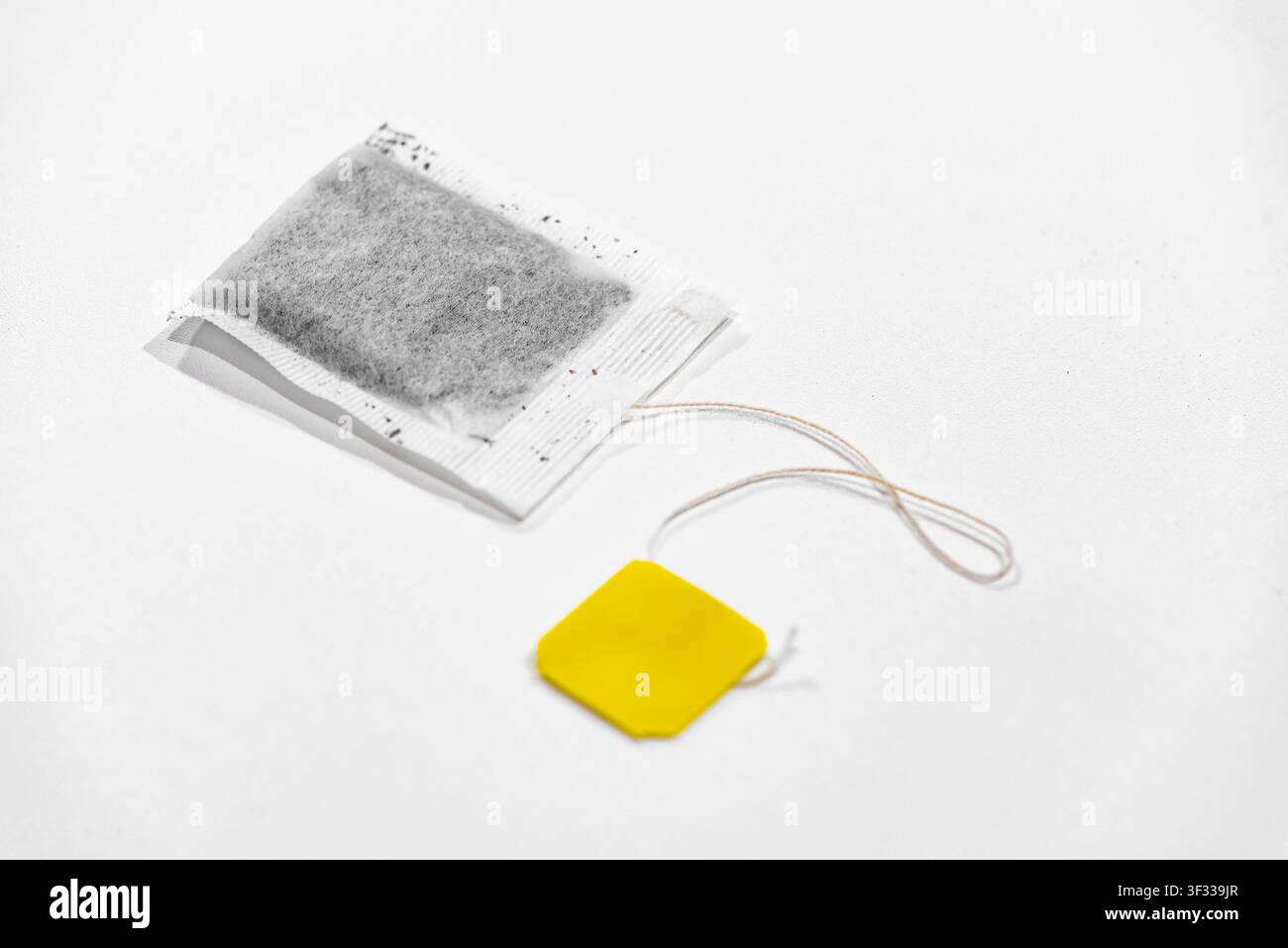 Single tea bag ready for brewing isolated on a clean white background Stock Photo