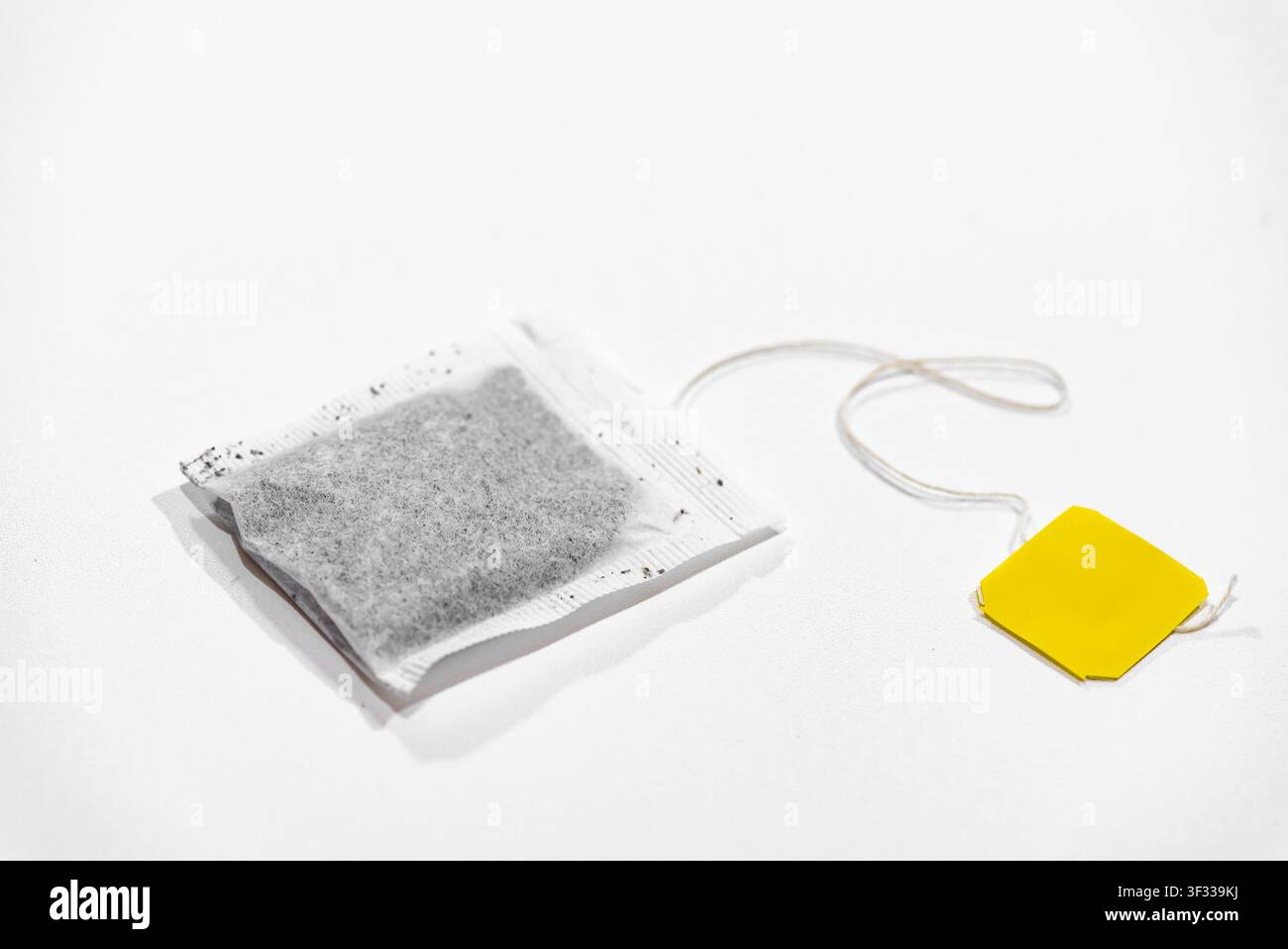 Single tea bag ready for brewing isolated on a clean white background Stock Photo