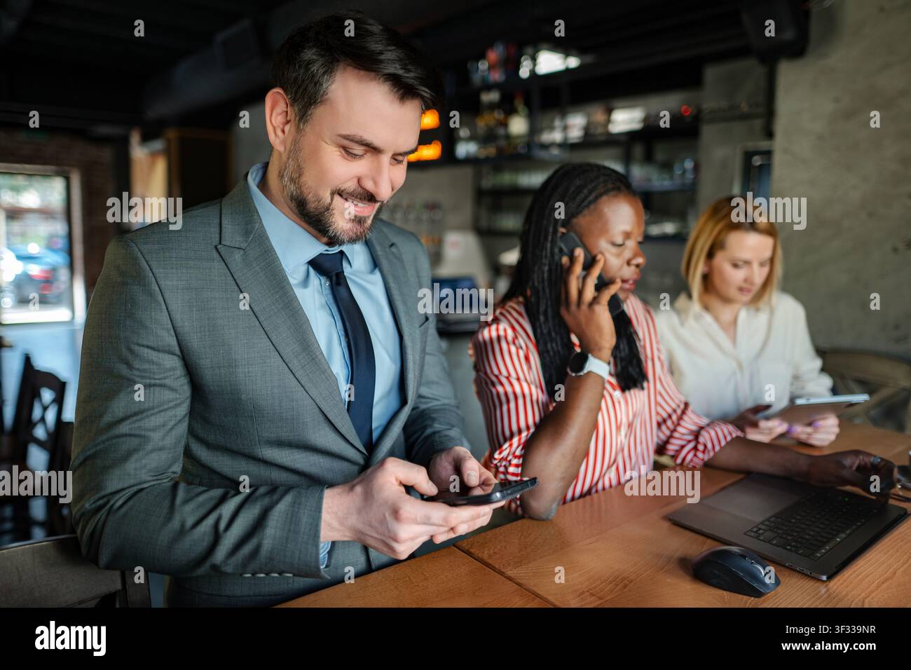Business professionals doing remote work at cafe Stock Photo