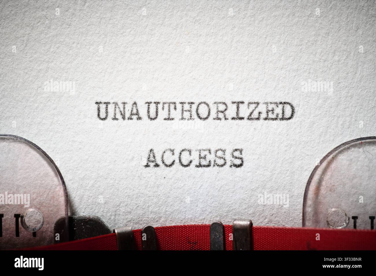 Unauthorized access text written with a typewriter. The system displays a security failure warning. Stock Photo
