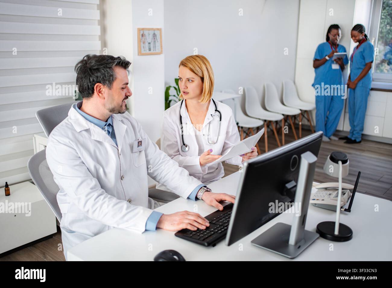 Doctors and nurses collaborating in hospital office Stock Photo
