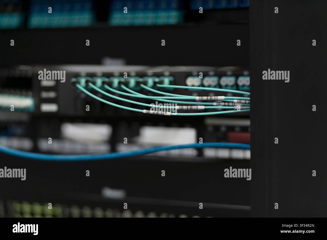 Network Server Rack with Patch Panels and Fiber Optic Cabling in Data Center Stock Photo