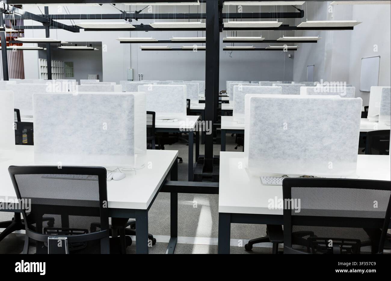 Wrapped in cover computers on places for workers in co-working Stock Photo