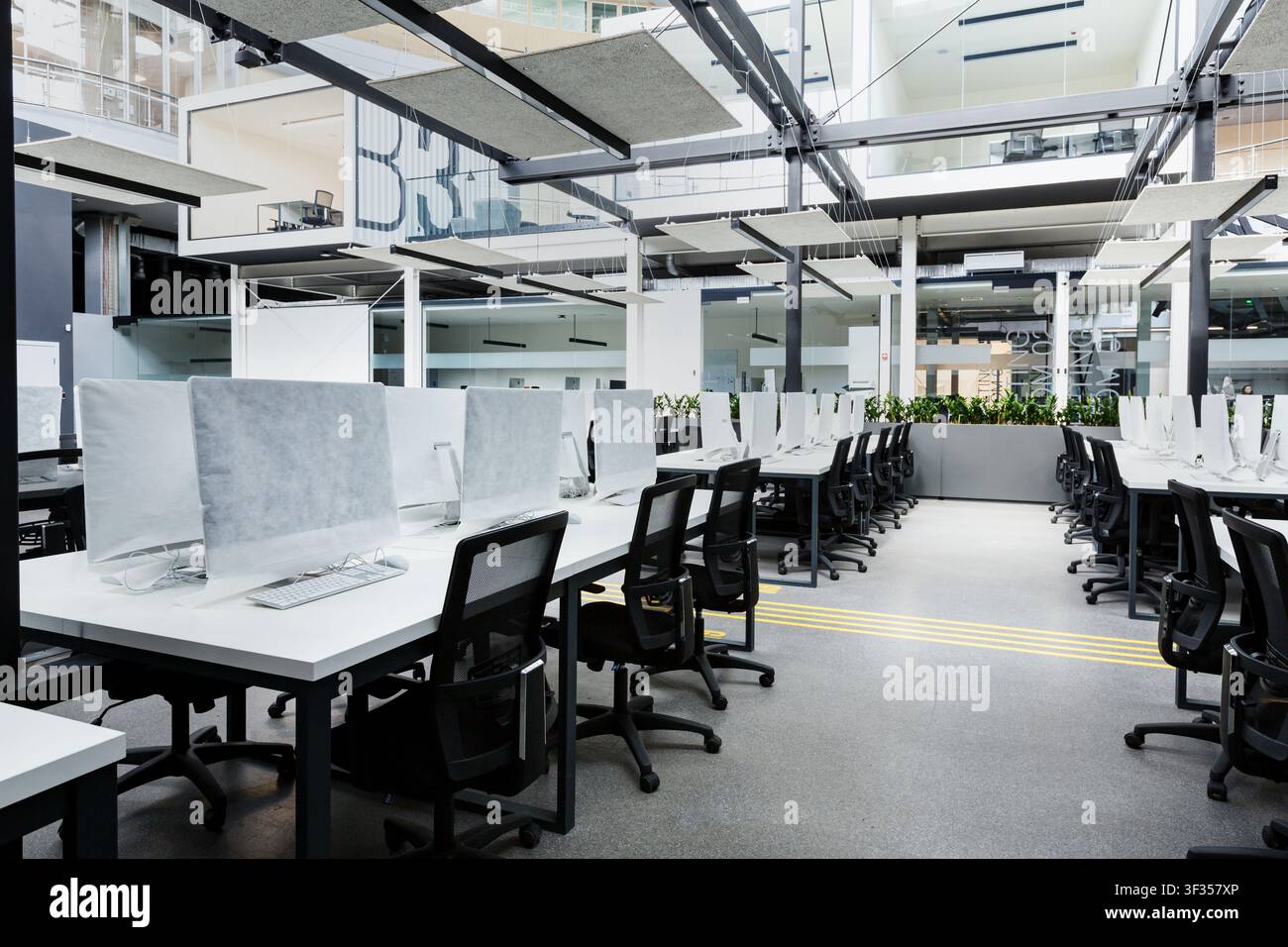 Big empty rental office with modern computers under cover Stock Photo