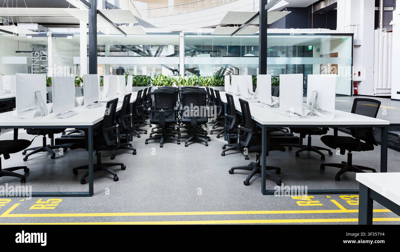 Co-working interior with many computers wrapped in cover Stock Photo