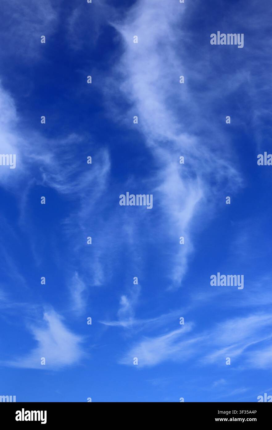 Cloudscape. Concepts - environment. Cirrus and cirrostratus clouds with a deep blue sky. Backgrounds. Copy space. Stock Photo