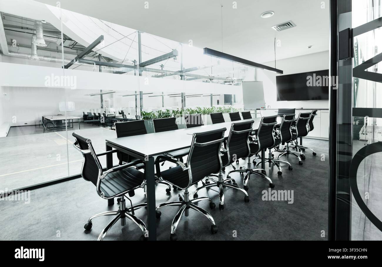 Table with chairs in conference room, modern loft office Stock Photo