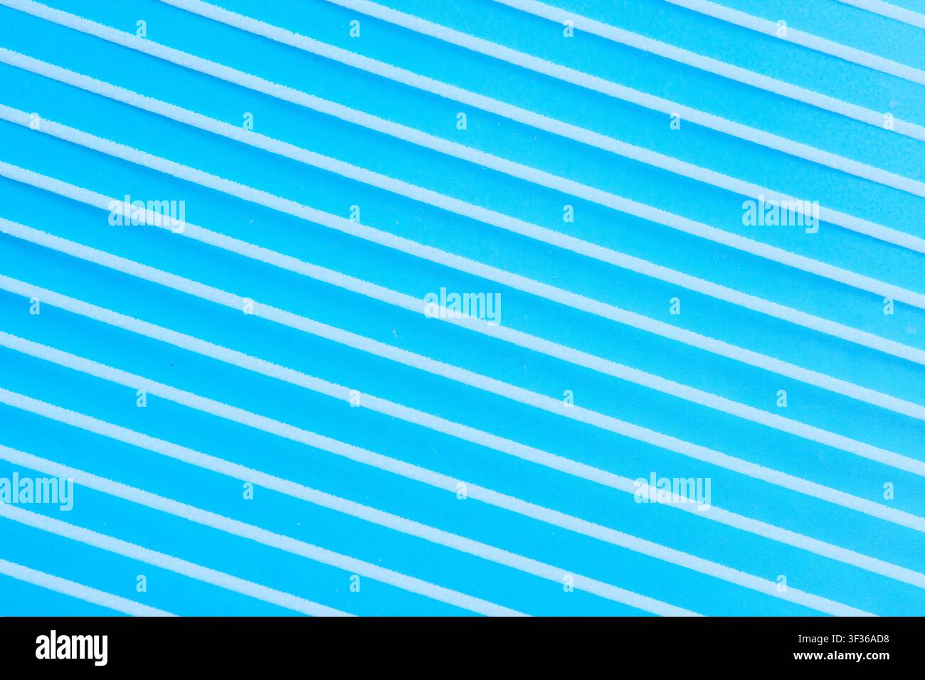 Diagonal white stripes pattern on bright blue background, abstract geometric textured surface Stock Photo