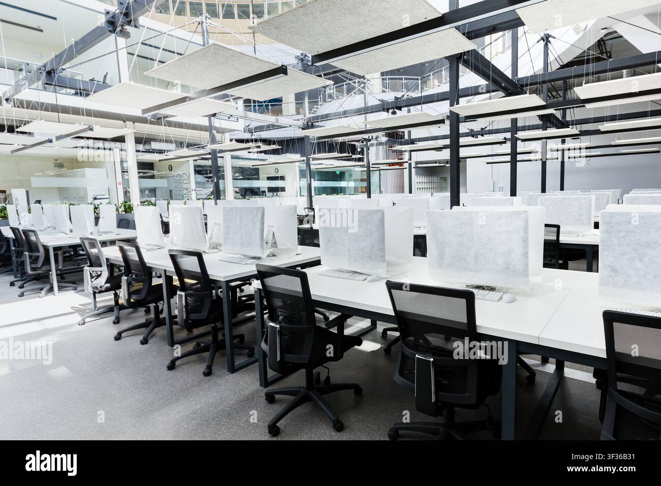 Big empty rental office for IT workers with wrapped in cover computers Stock Photo