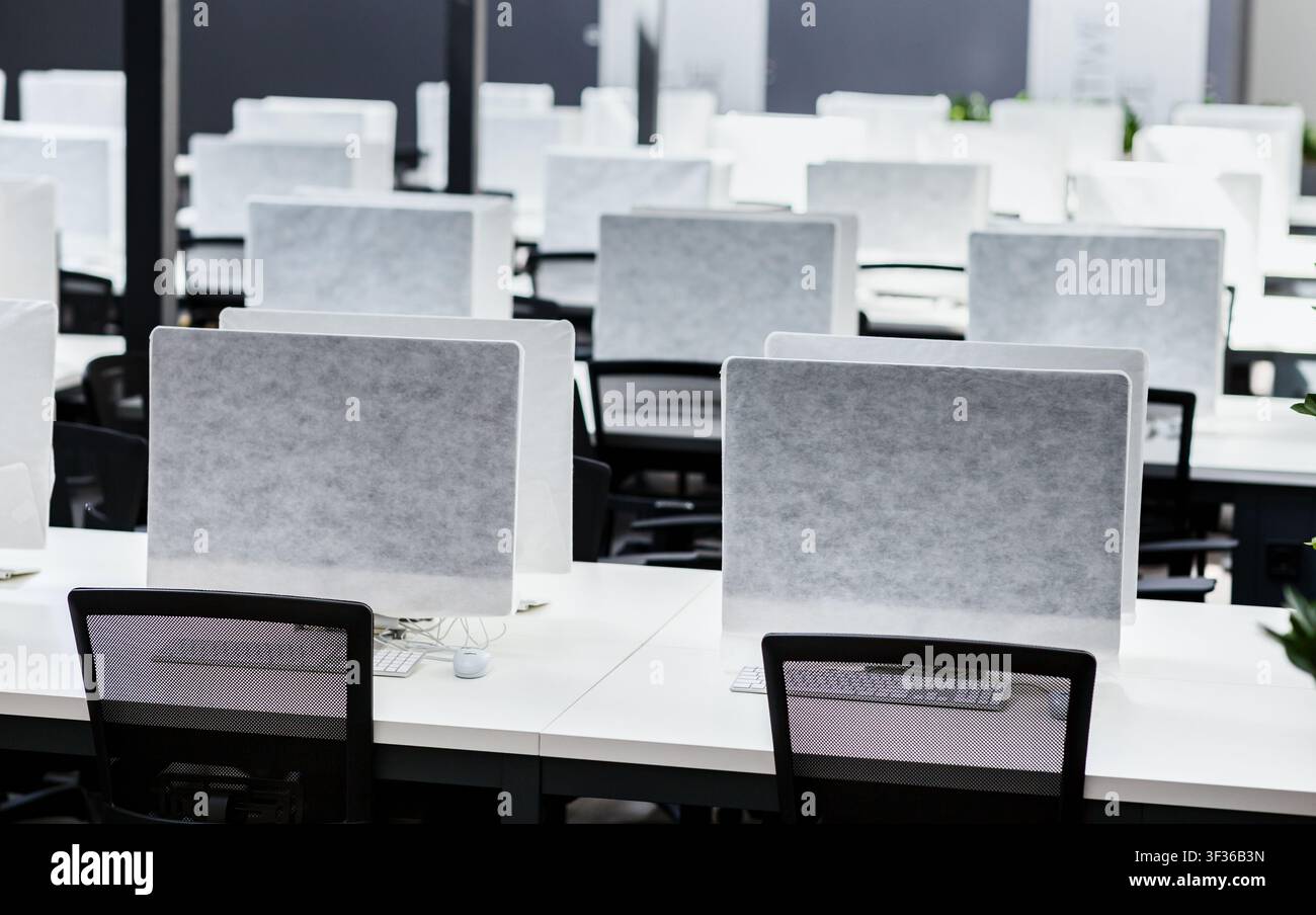 Empty places for workers in big empty rental office Stock Photo