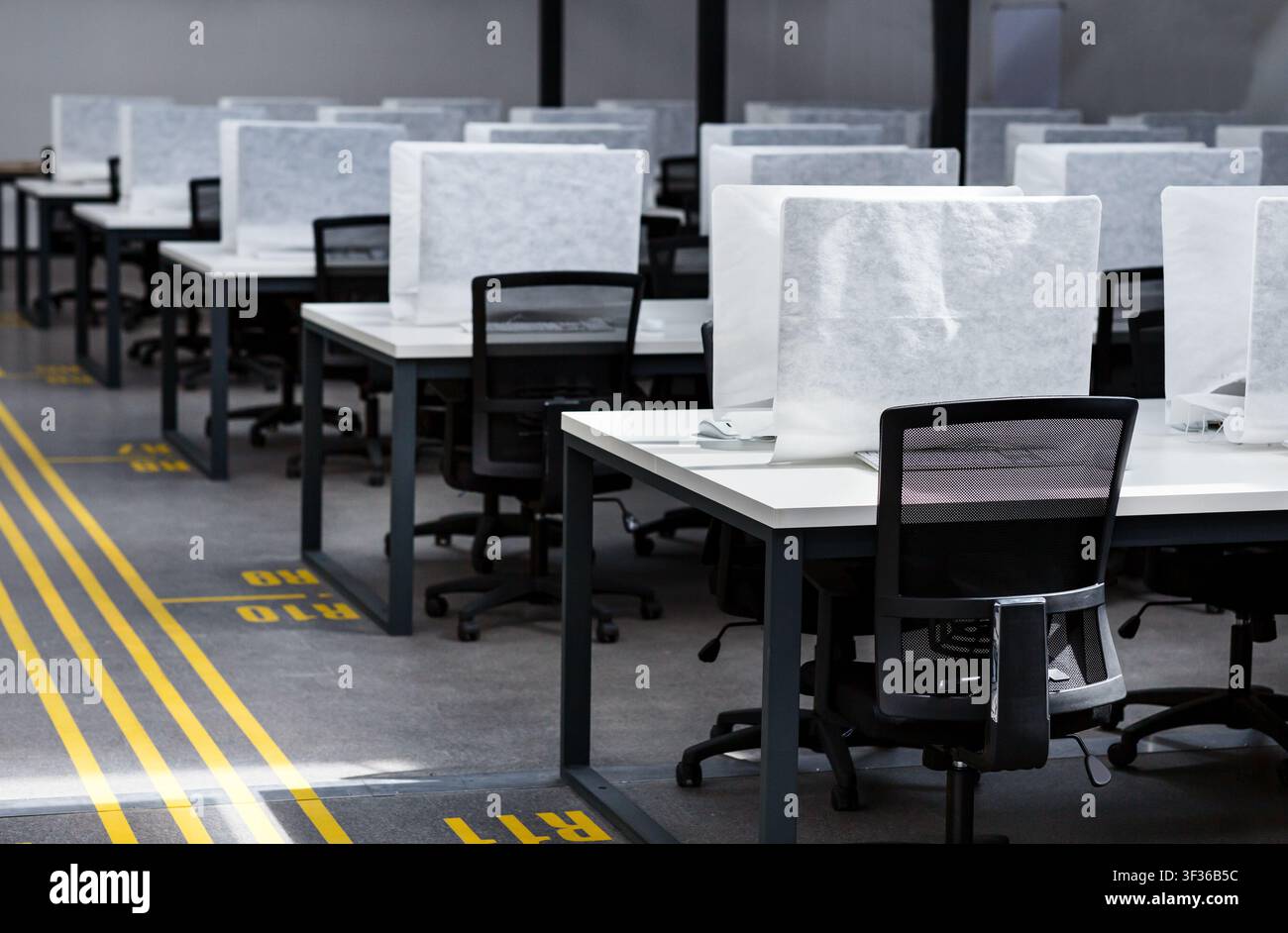 Office interior many covered computers and workplaces with no people Stock Photo