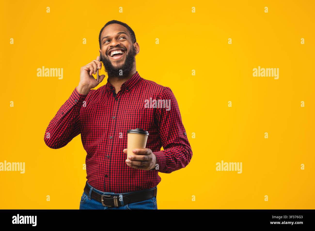 Smiling black guy talking on the phone at studio Stock Photo