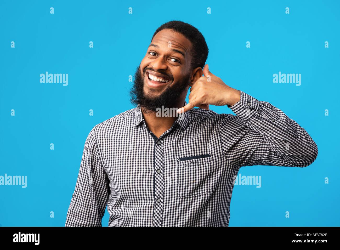 Afro man doing phone gesture at studio Stock Photo