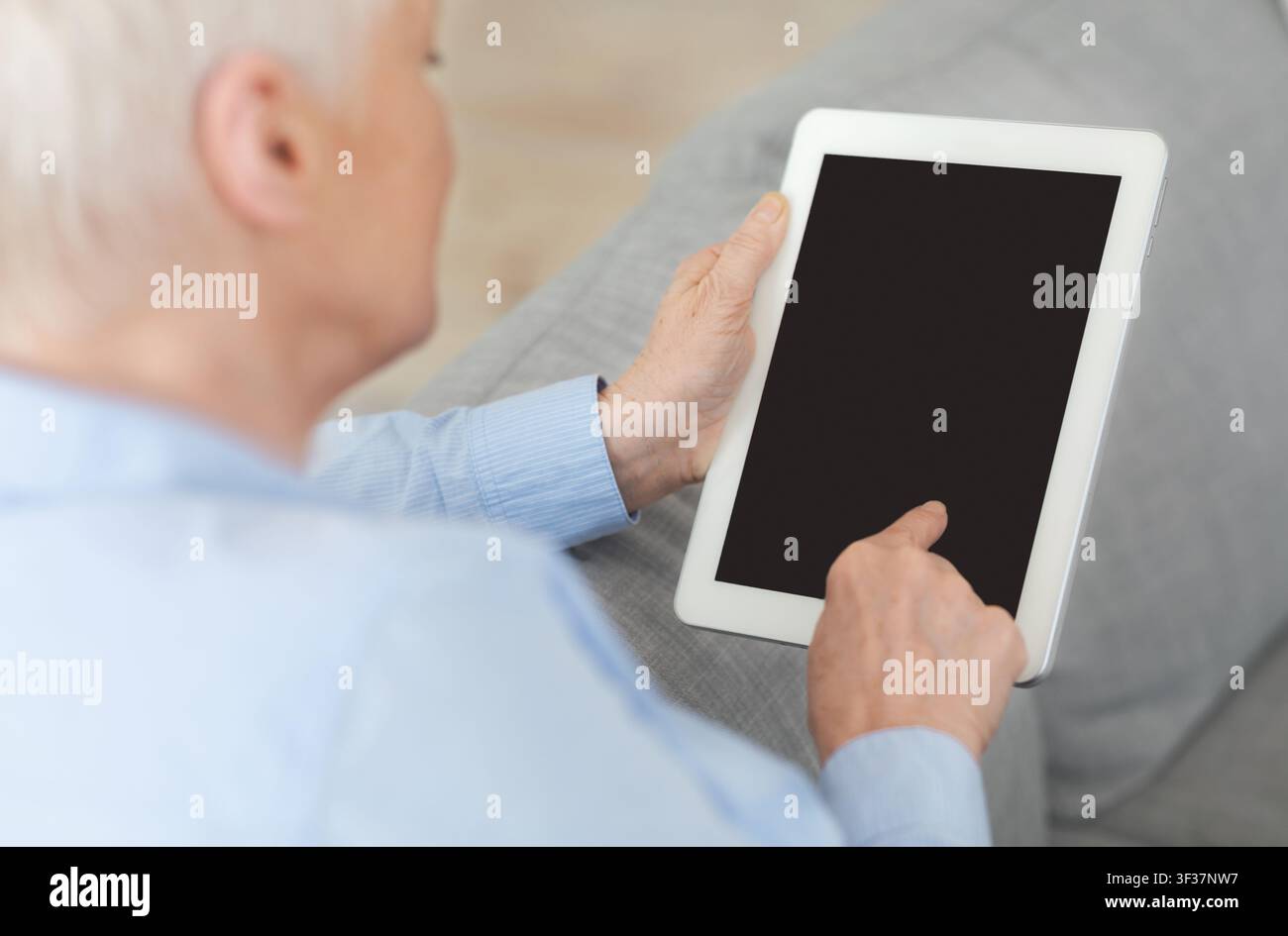 Unrecognizable Senior Woman Using Digital Tablet With Blank Screen At Home, Mockup Stock Photo