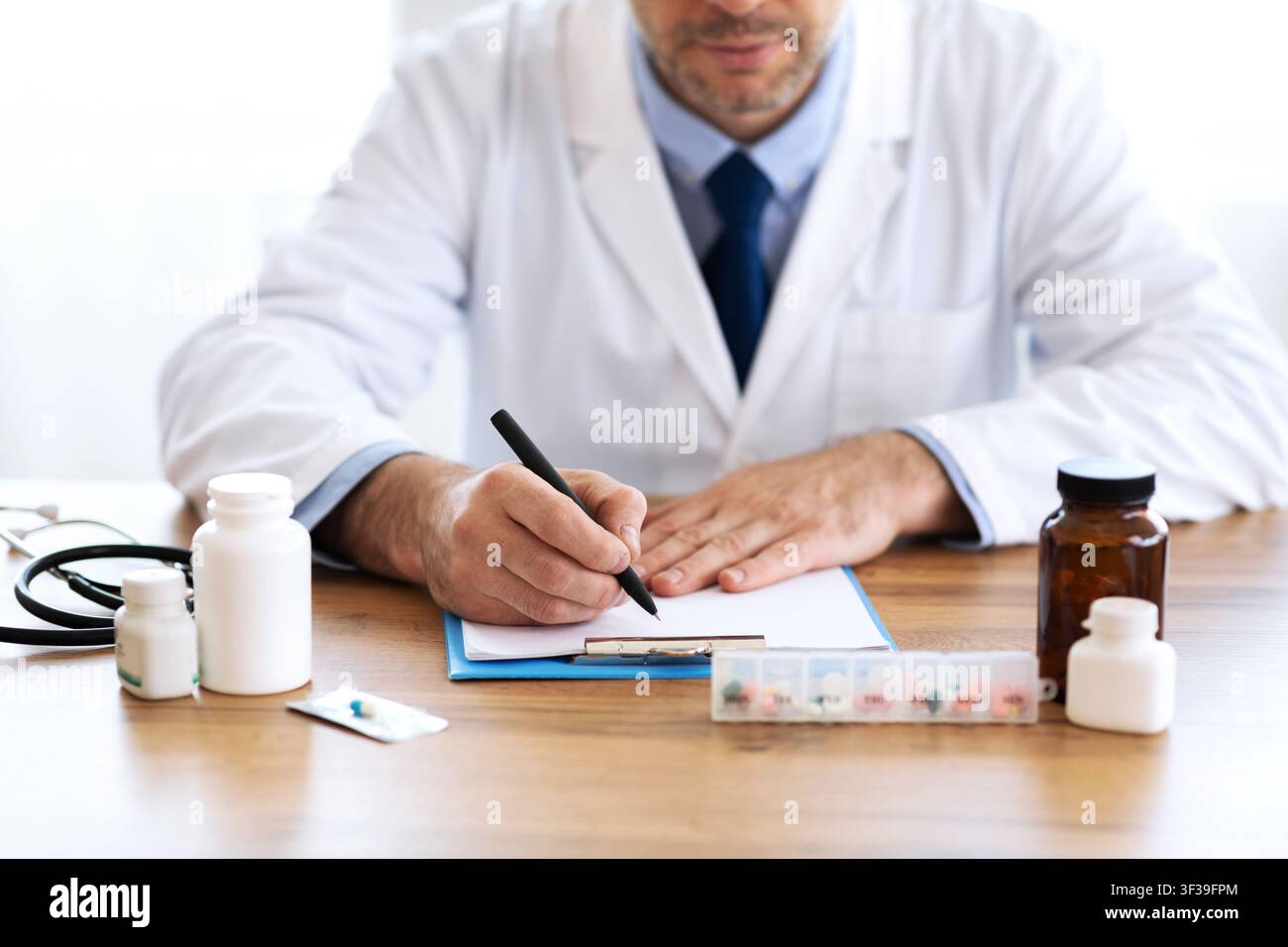 Close up of medical practitioner writing prescription Stock Photo