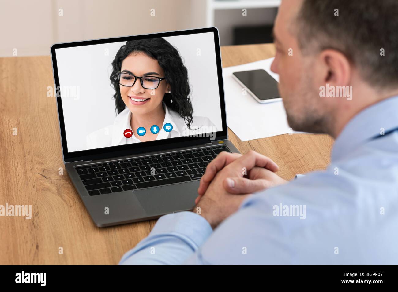 Workers having online discussion during video call at home Stock Photo