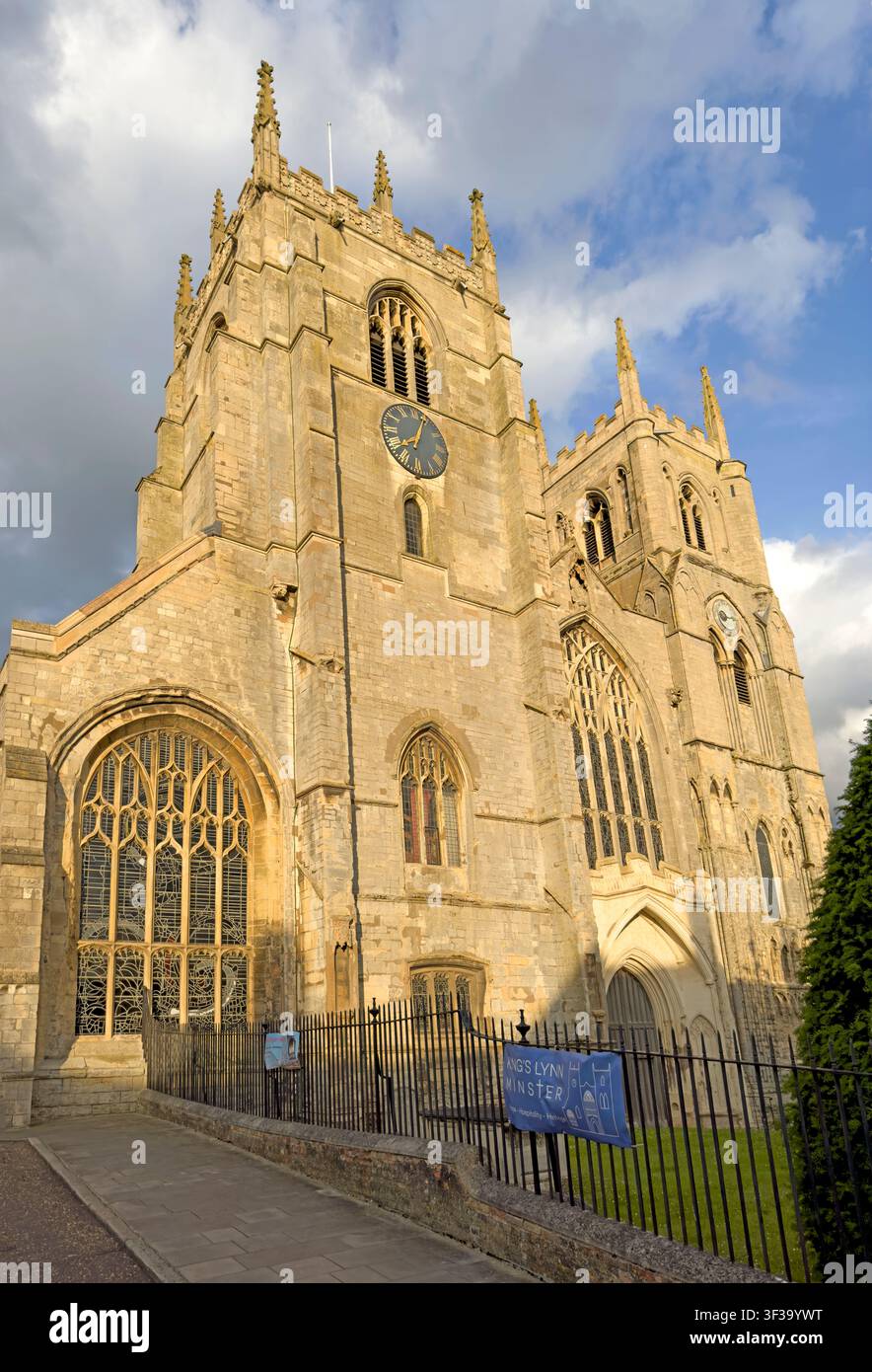 Evening view of the medieval King's Lynn Minster, with its twin west towers, Gothic windows and historic stone facade Stock Photo