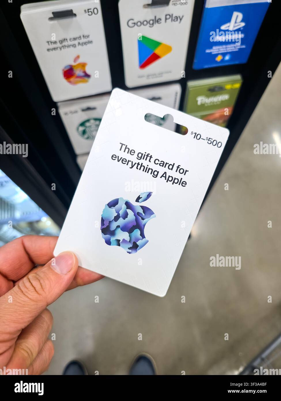 PLANO, TX, 2026 - JULY 12, 2026: An individual holds an Apple gift card in a retail store. The card displays a colorful Apple logo, emphasizing its us Stock Photo